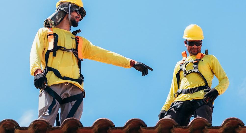 construction workers collaborating on rooftop
